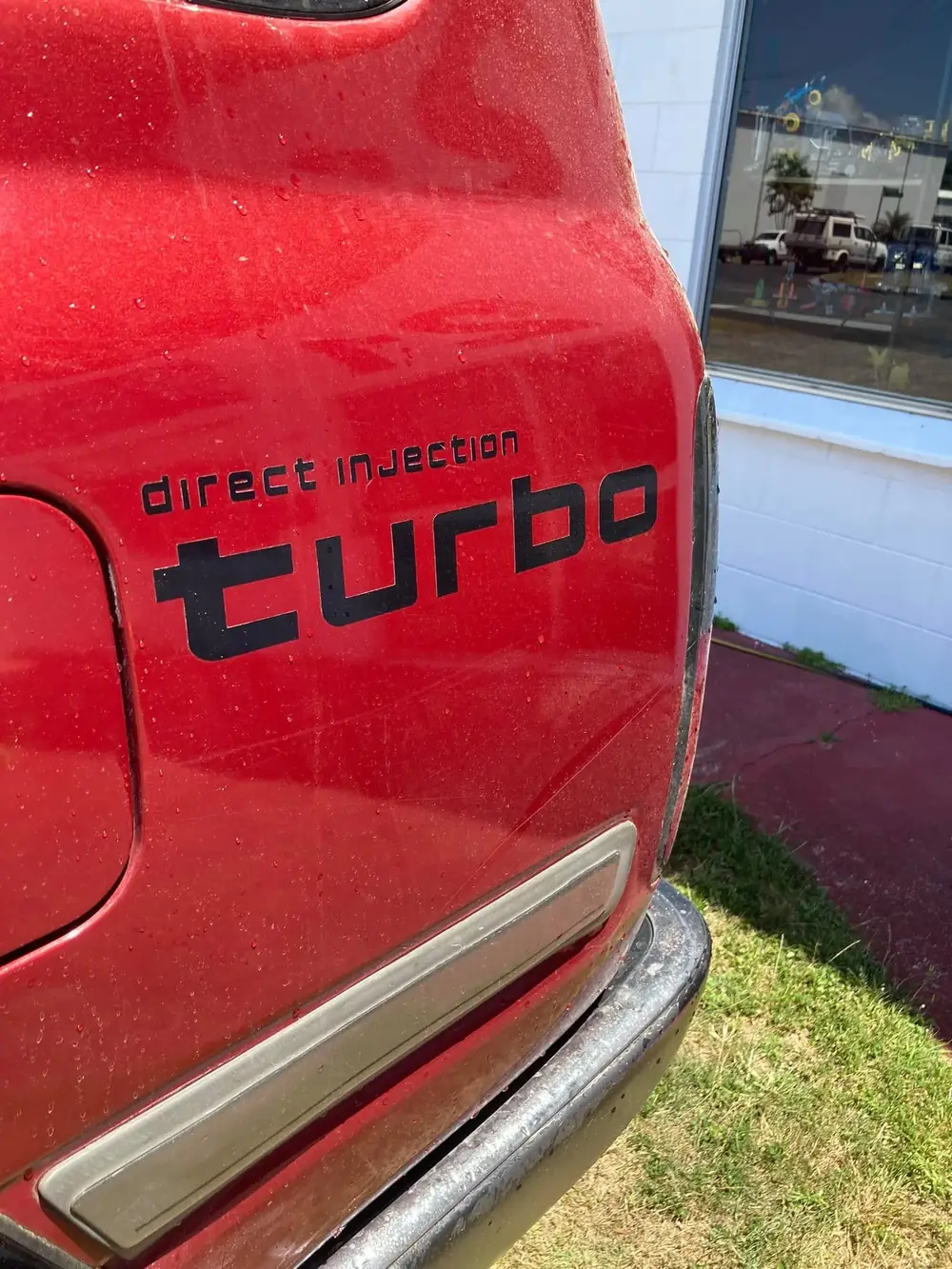 The rear badge of a turbo diesel ute parked outside the SJB Mechanical workshop