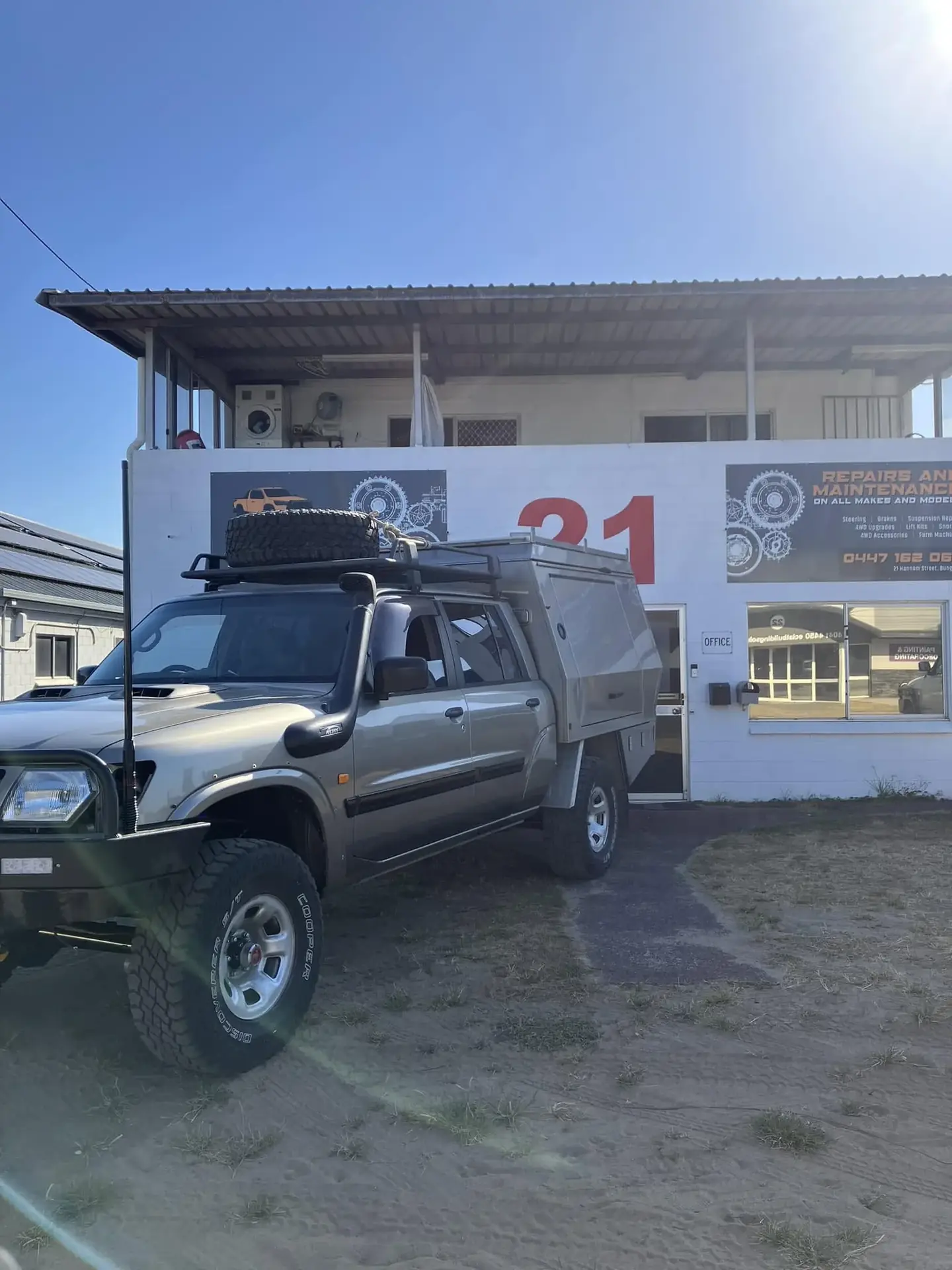 The SJB Mechanical workshop signage and office, with a lifted 4WD parked in front
