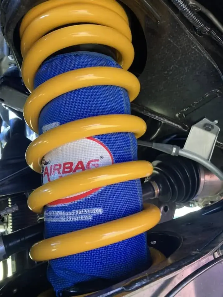 A close-up of a 4WD suspension airbag and coil spring assembly